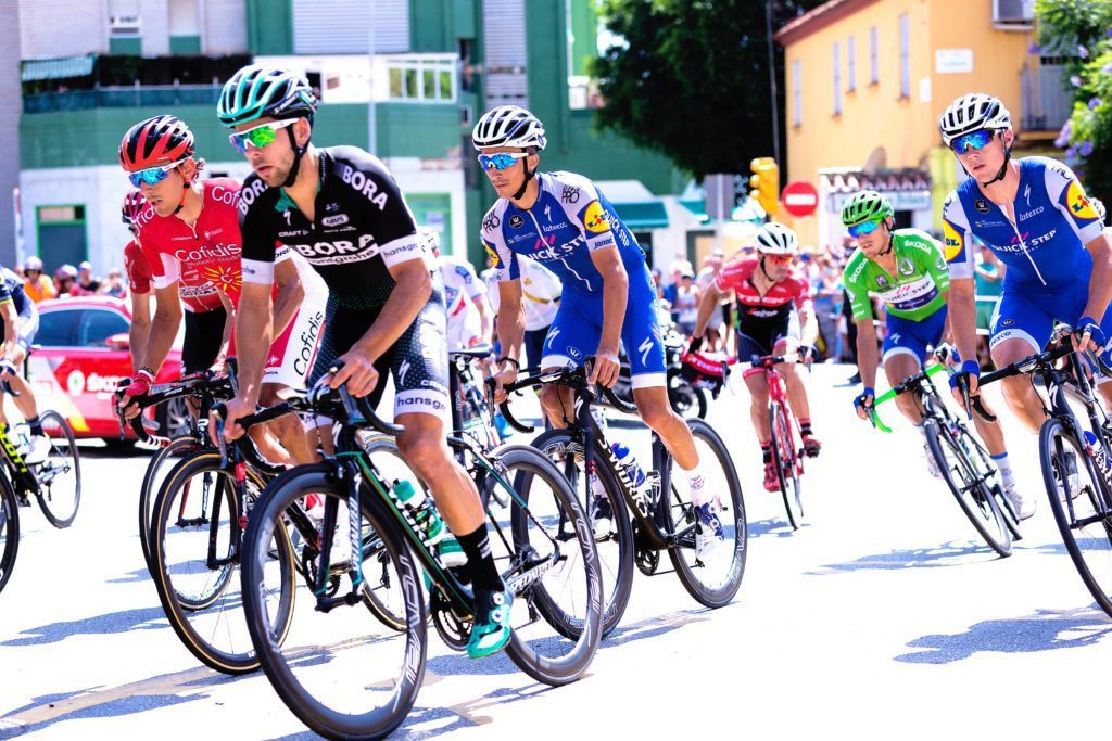 Group of cyclists racing through a city centre